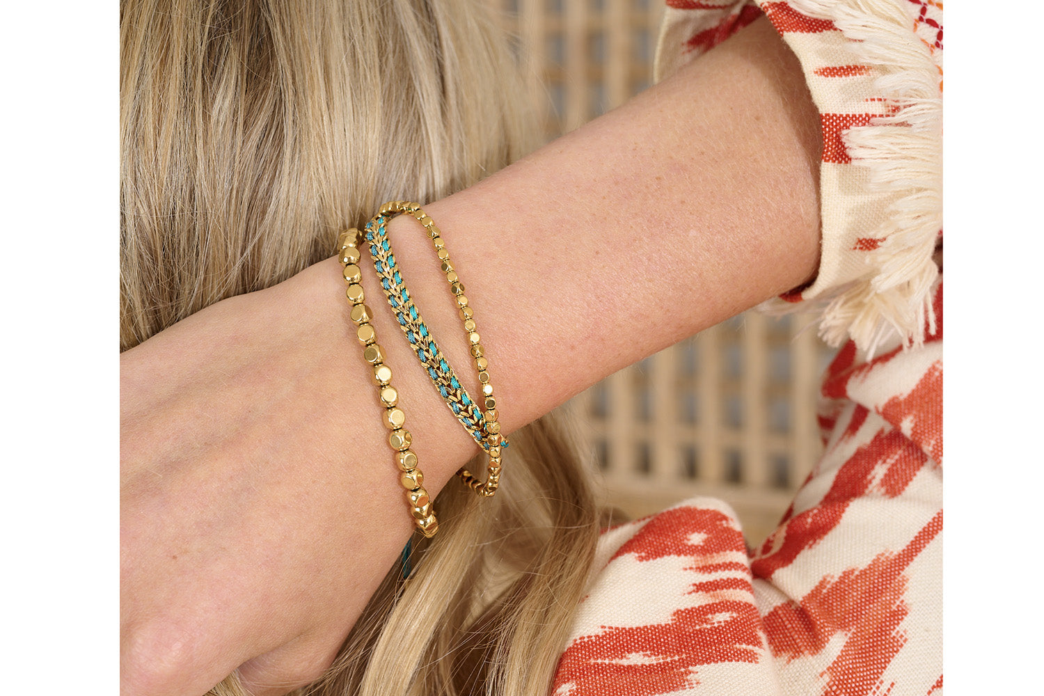 Golden Stretch bracelets complimenting the teal tones of the Cari with old plating.