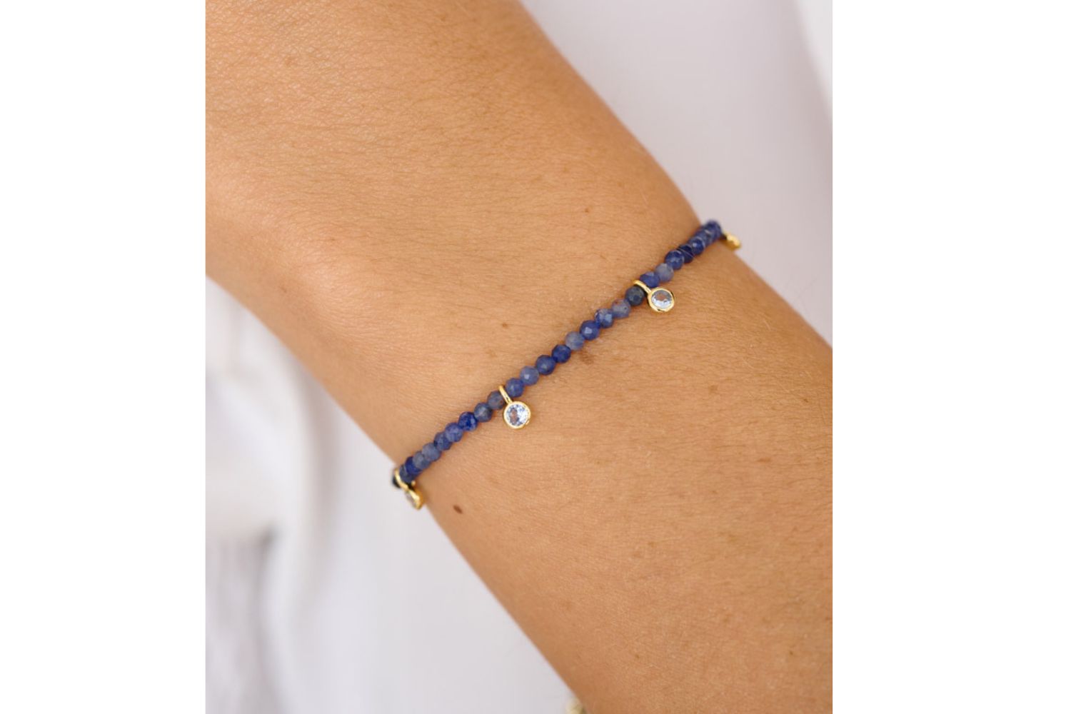 Lifestyle shot showcasing the Holly blue aventurine thread slider friendship bracelet