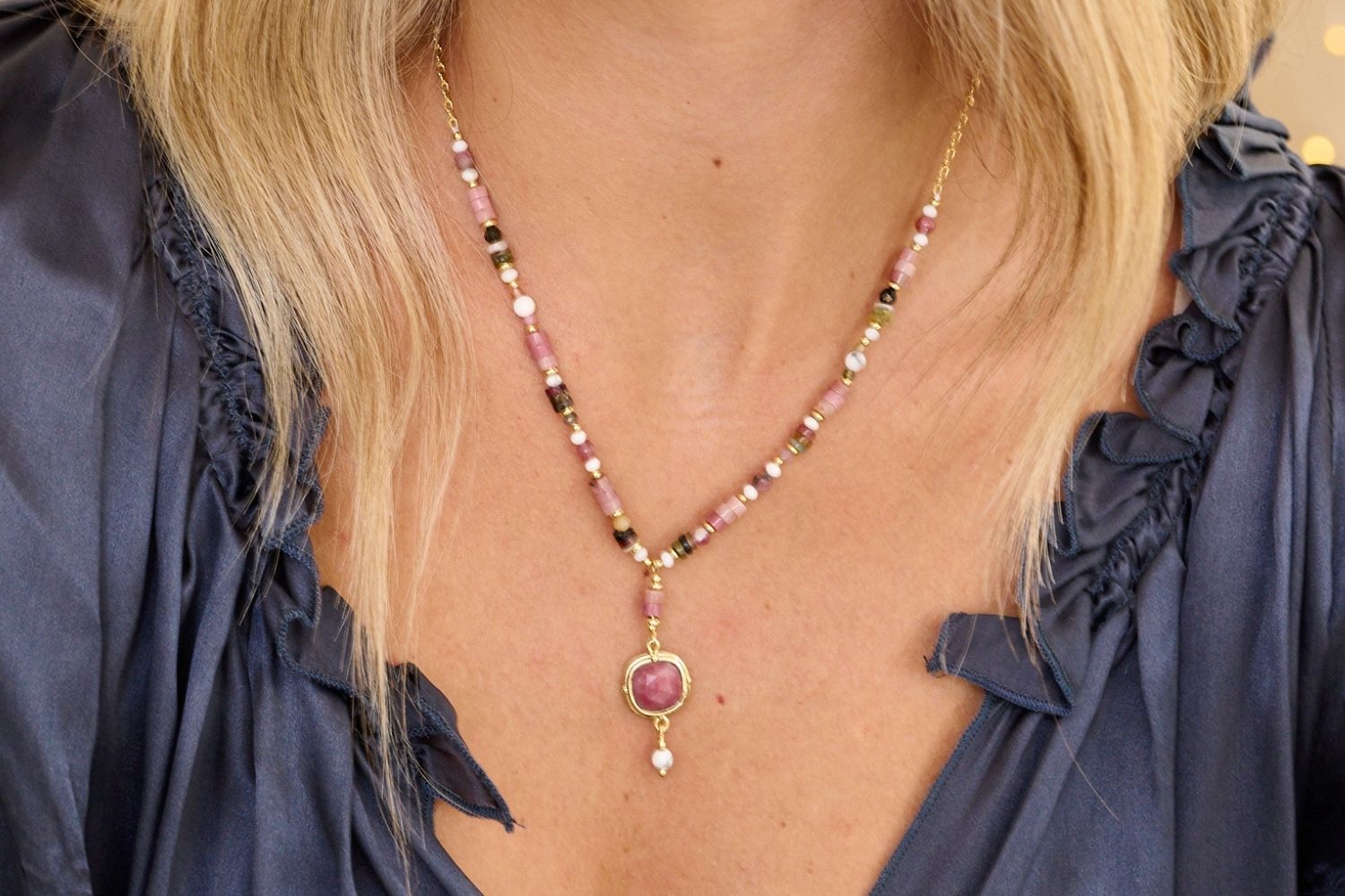 Lifestyle picture showing the Boho Betty Pink Tourmaline Metis Pendant Gold Necklace