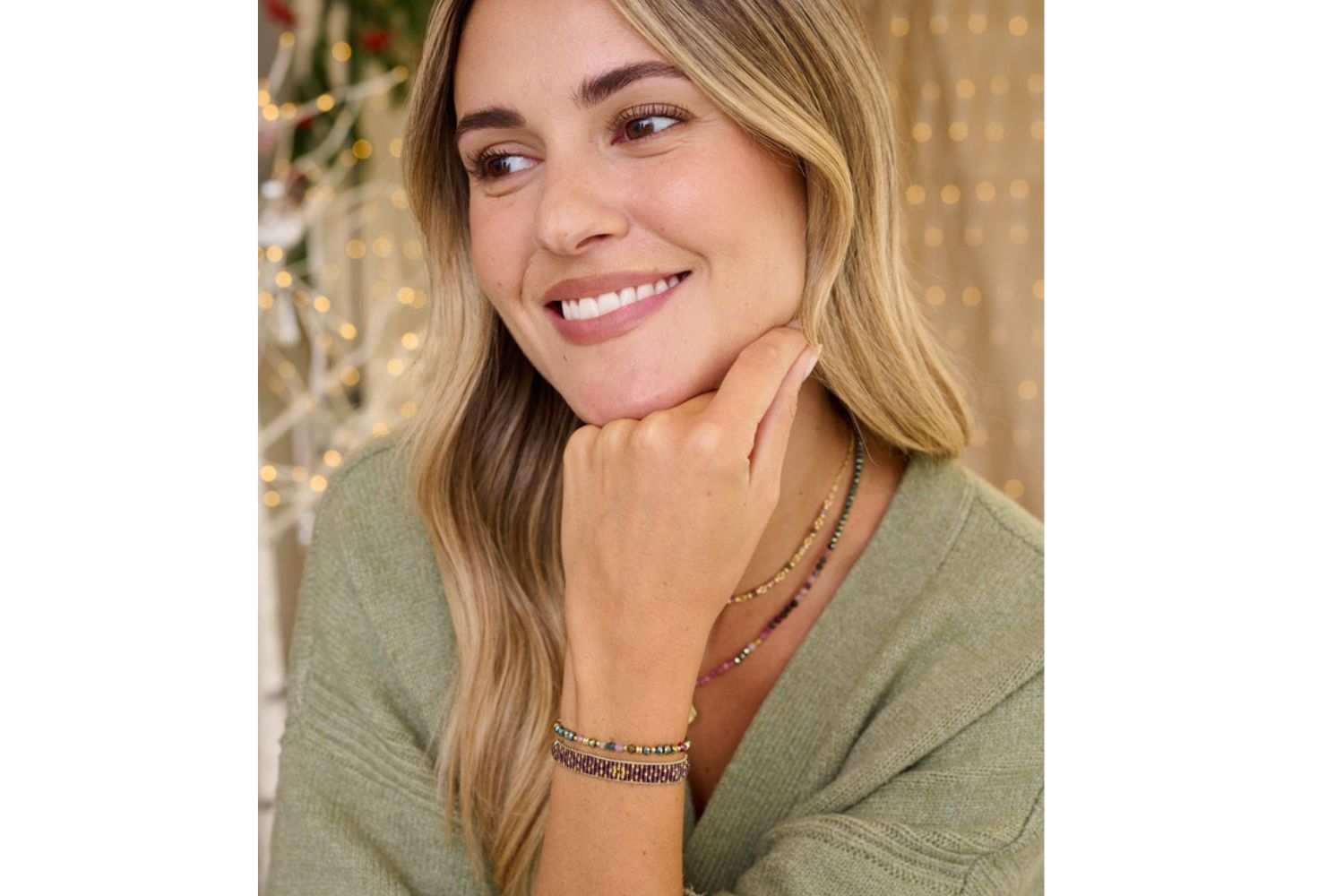 Lifestyle image showcasing the olive tourmaline bracelet as part of a necklace braces set with Umino Tourmaline set. The olive tourmaline bracelet is layered beautifully next to the Maya mulberry beaded bracelet for an effortless look.