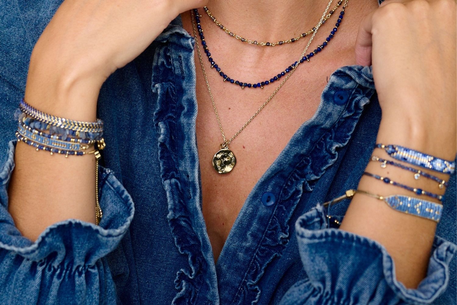 Woman wearing stack of Lapis Lazuli and Gold Gemstone Necklaces 