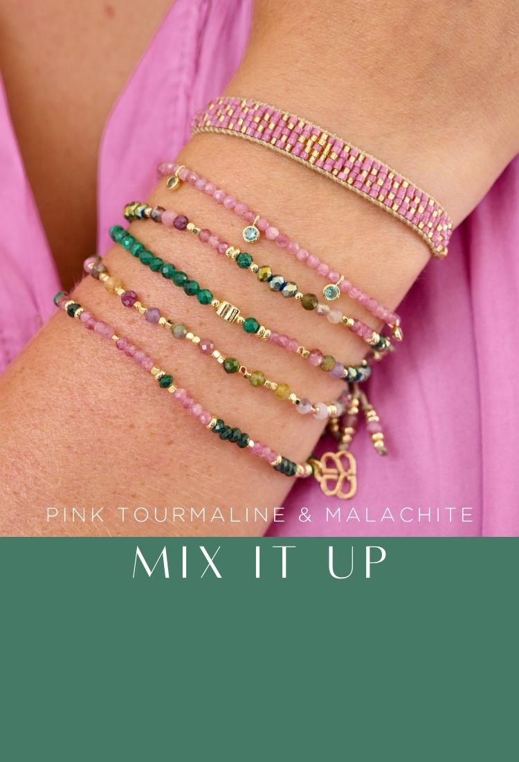 Close-up of a wrist adorned with pink tourmaline and malachite bracelets, featuring various textures and bead styles. Text reads 'Pink Tourmaline & Malachite - Mix It Up.’