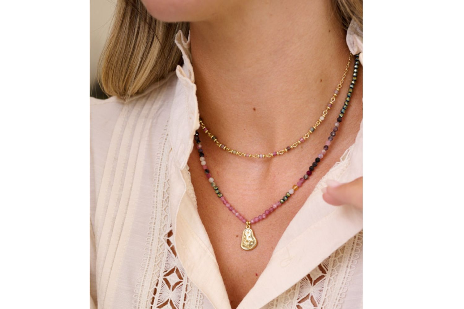 Lifestyle picture showcasing the Umino tourmaline necklace layered beautifully with the panacea tourmaline gold necklace