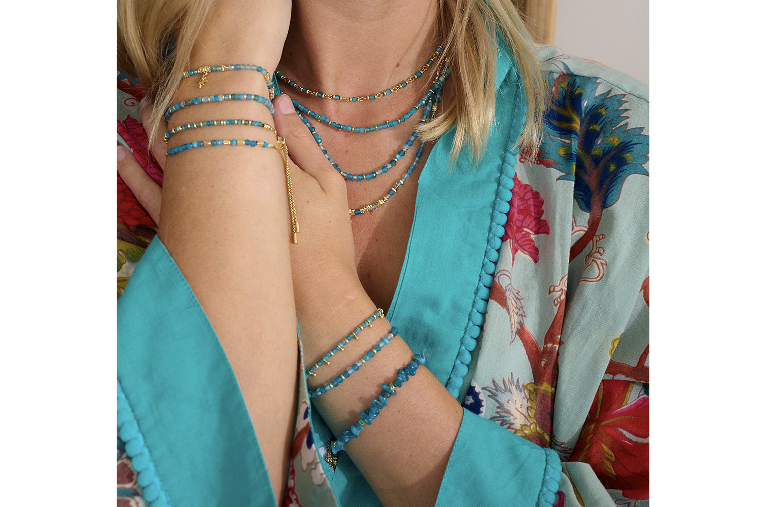 Arabella Apatite & Blue Topaz Gold Slider Bracelet styled on the wrist, showcasing vibrant blue gemstone beads, gold accents, and a boho-chic adjustable slider.