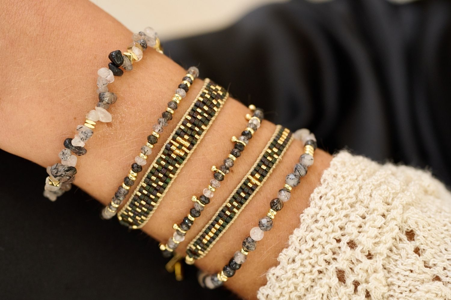 Aslan Gold & Black Beaded Friendship Bracelet styled on the wrist, showcasing black beads and shimmering gold accents, perfect for a night out or elegant occasions.