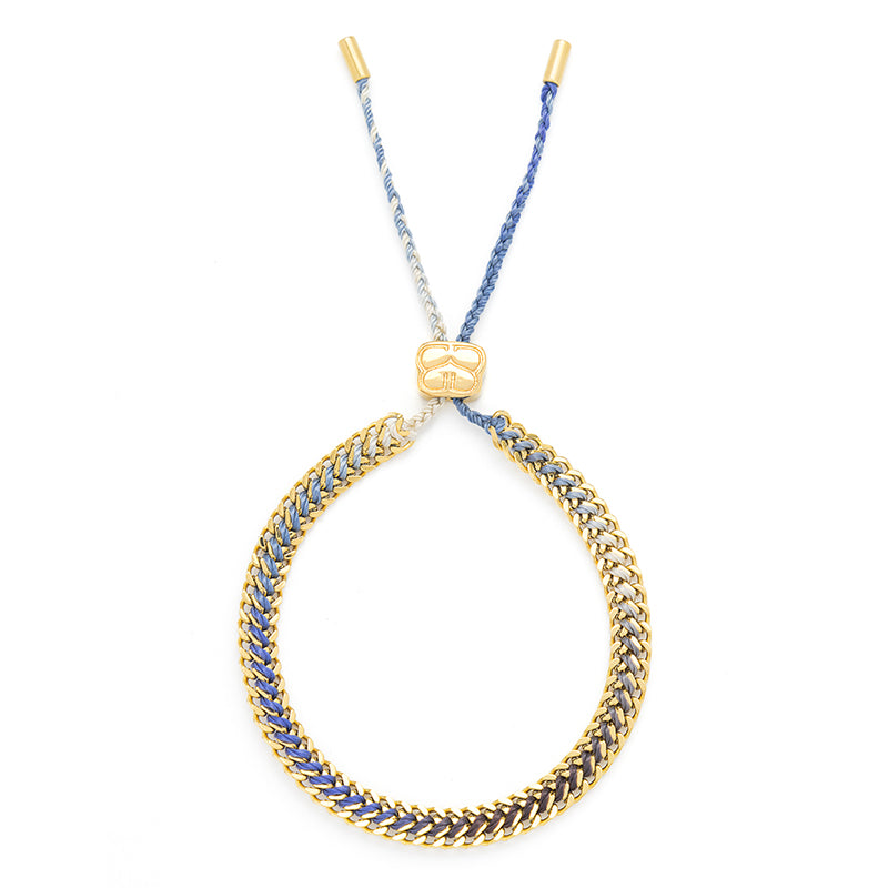 Athena Denim Gold Braided Bracelet styled on the wrist, featuring a blue ombre thread and gold curb chain accents, ideal for summer adventures and effortless elegance.