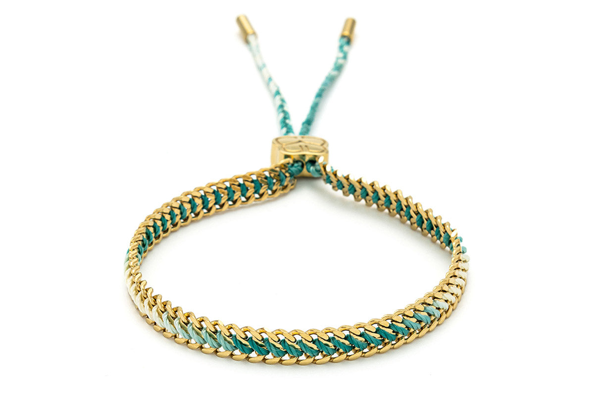 Athena Turquoise Gold Braided Bracelet featuring turquoise ombre thread and 14k gold-plated curb chain, inspired by tropical waters and beachy style.