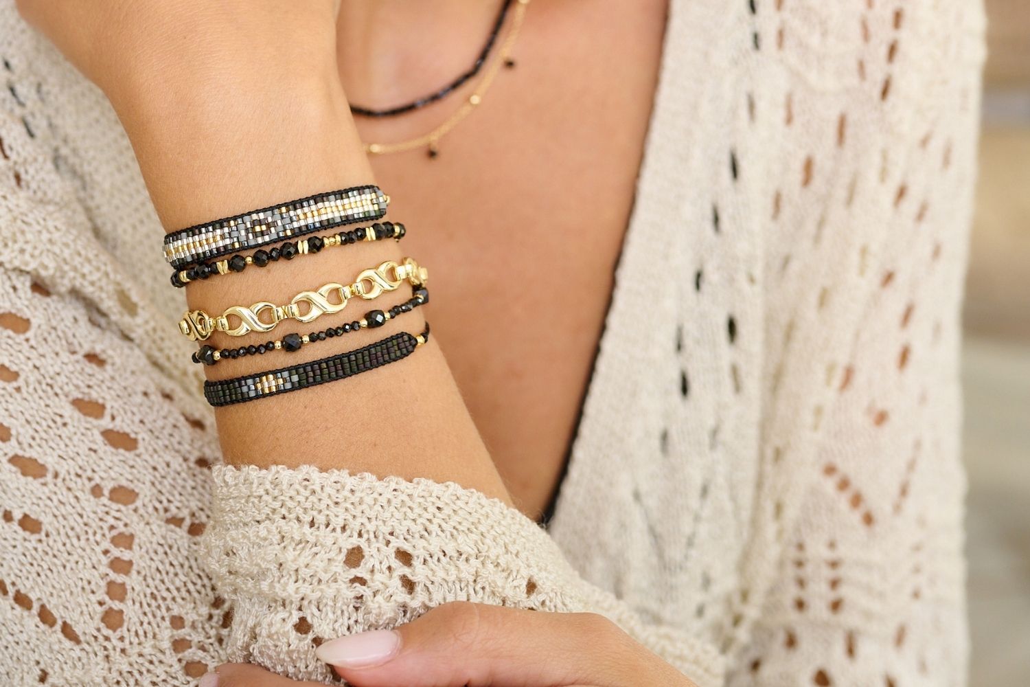 Fantasy Black & Gold Beaded Friendship Bracelet styled on the wrist, featuring black Miyuki beads and gold accents, perfect for layering or wearing solo.