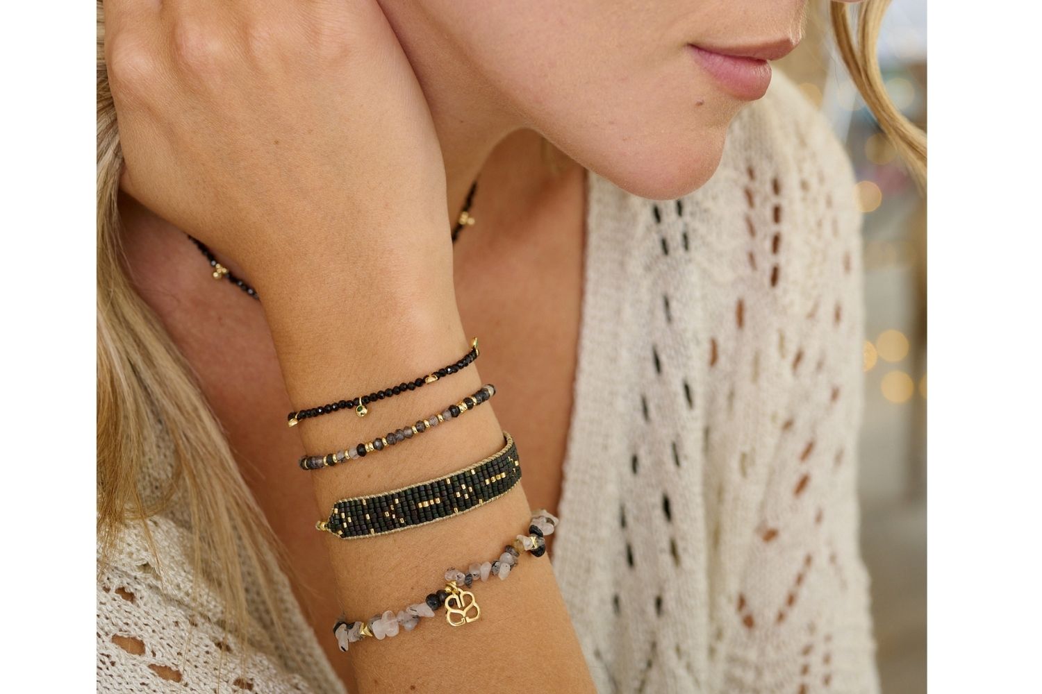 Holly Gold & Black Spinel Gemstone Charm Bracelet styled on the wrist, featuring black Spinel beads, green charms, and gold accents, perfect for layering or wearing solo.