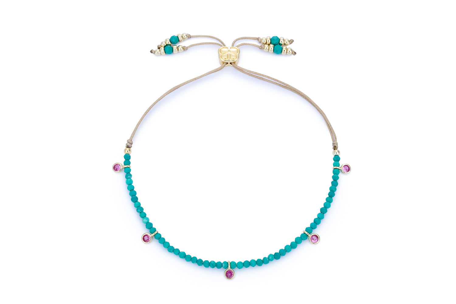 Holly Turquoise Howlite & Pink Crystal Charm Bracelet featuring vibrant turquoise howlite beads, pink crystal accents, and 12k gold-plated brass details with an adjustable slider fastening.