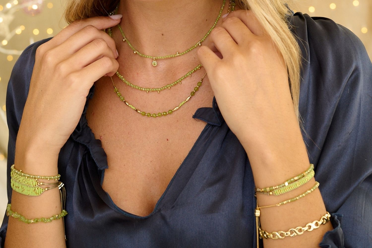 Horus Peridot Gemstone Necklace styled on model, featuring faceted peridot beads with gold accents, making it a meaningful August birthstone gift.