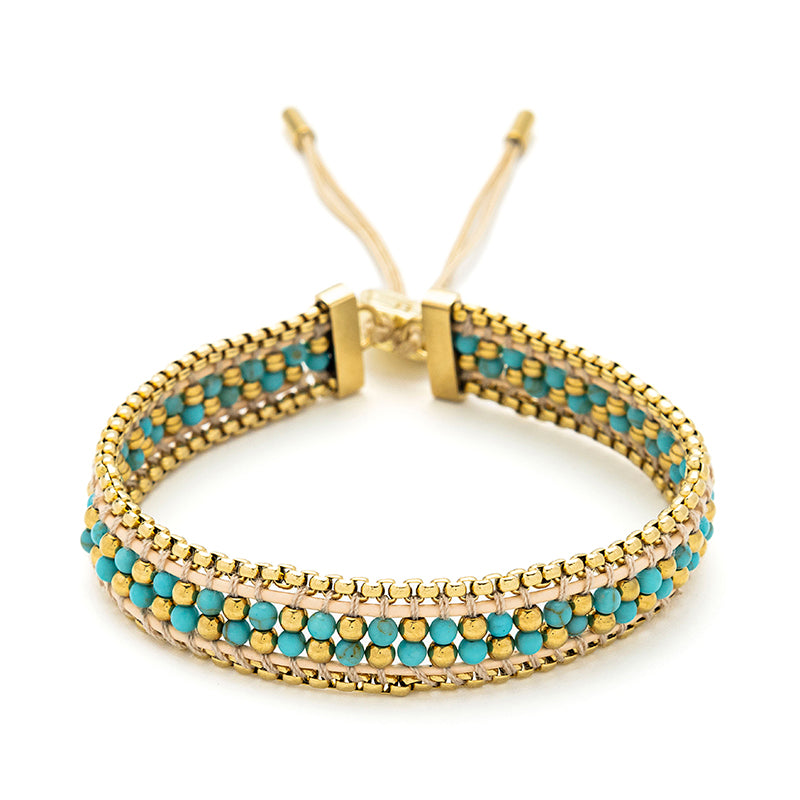 Isla Turquoise Gold Braided Bracelet with turquoise howlite beads, 14k gold-plated snake chain, and an adjustable slider, ideal for holiday jewellery and beach-inspired style.