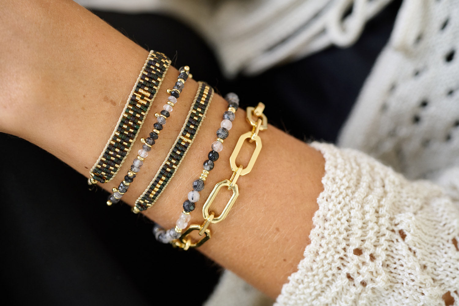 Keramas Black Rutilated Quartz Gold Bracelet Stack styled on the wrist, showcasing faceted gemstones and luxurious gold accents, perfect for night-time elegance.