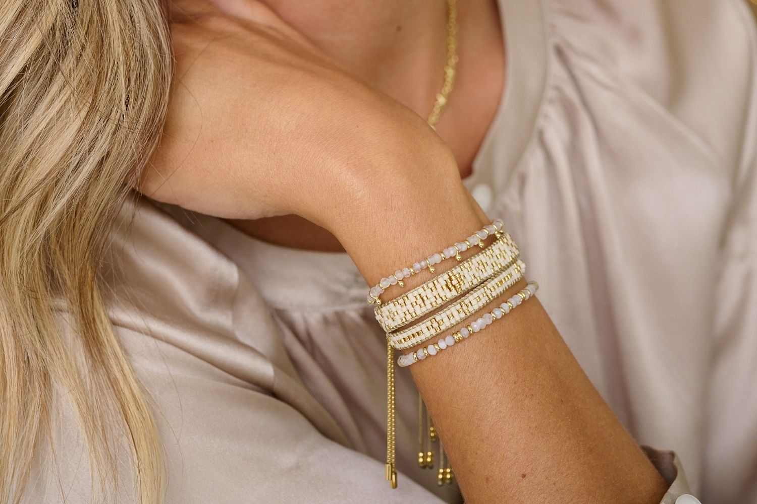 Maya Cream Gold Beaded Friendship Bracelet styled with a chic outfit, showcasing its smooth cream Miyuki beads and shimmering 12k gold-plated accents.