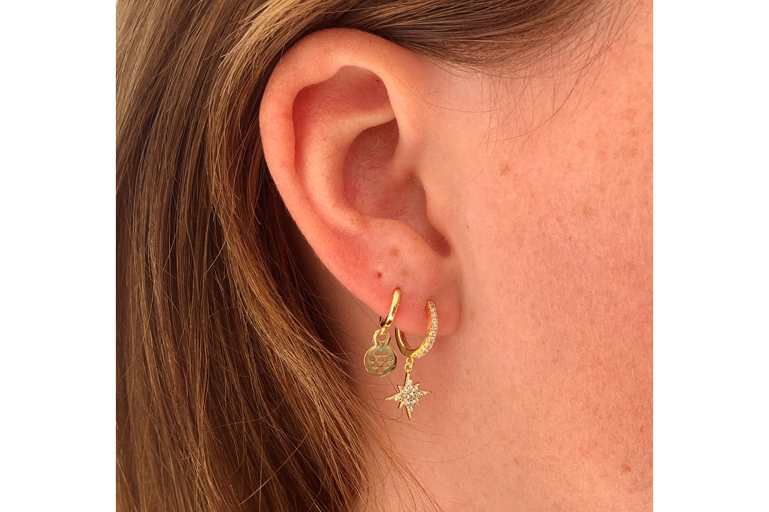 Cohan Gold CZ Star Hoop Earrings styled elegantly, showcasing 14k gold-plated hoops and sparkling CZ star charms for a celestial look.