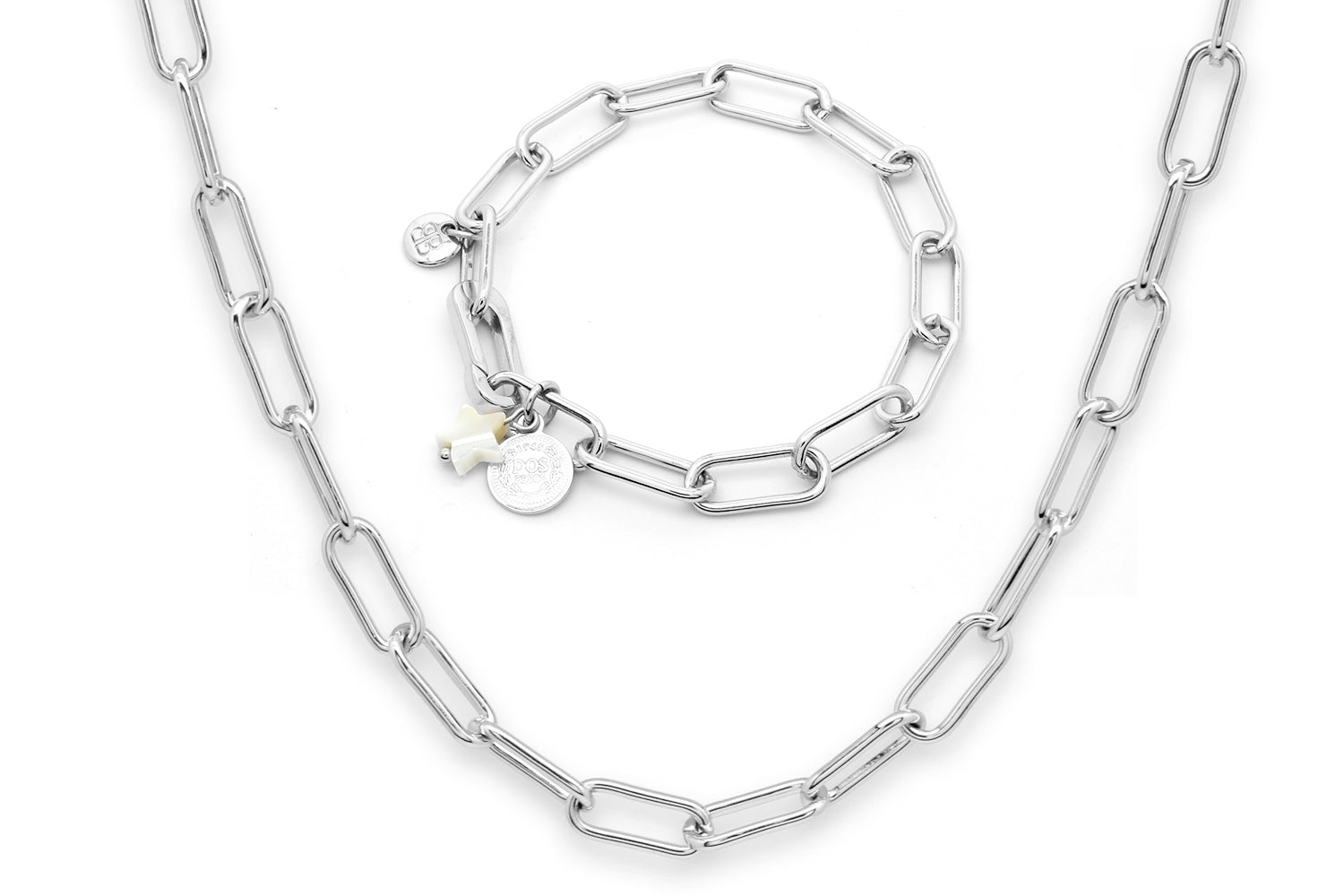 Notus Silver Necklace and Bracelet Set featuring bold geometric links and playful coin and star charms, crafted in polished sterling silver.